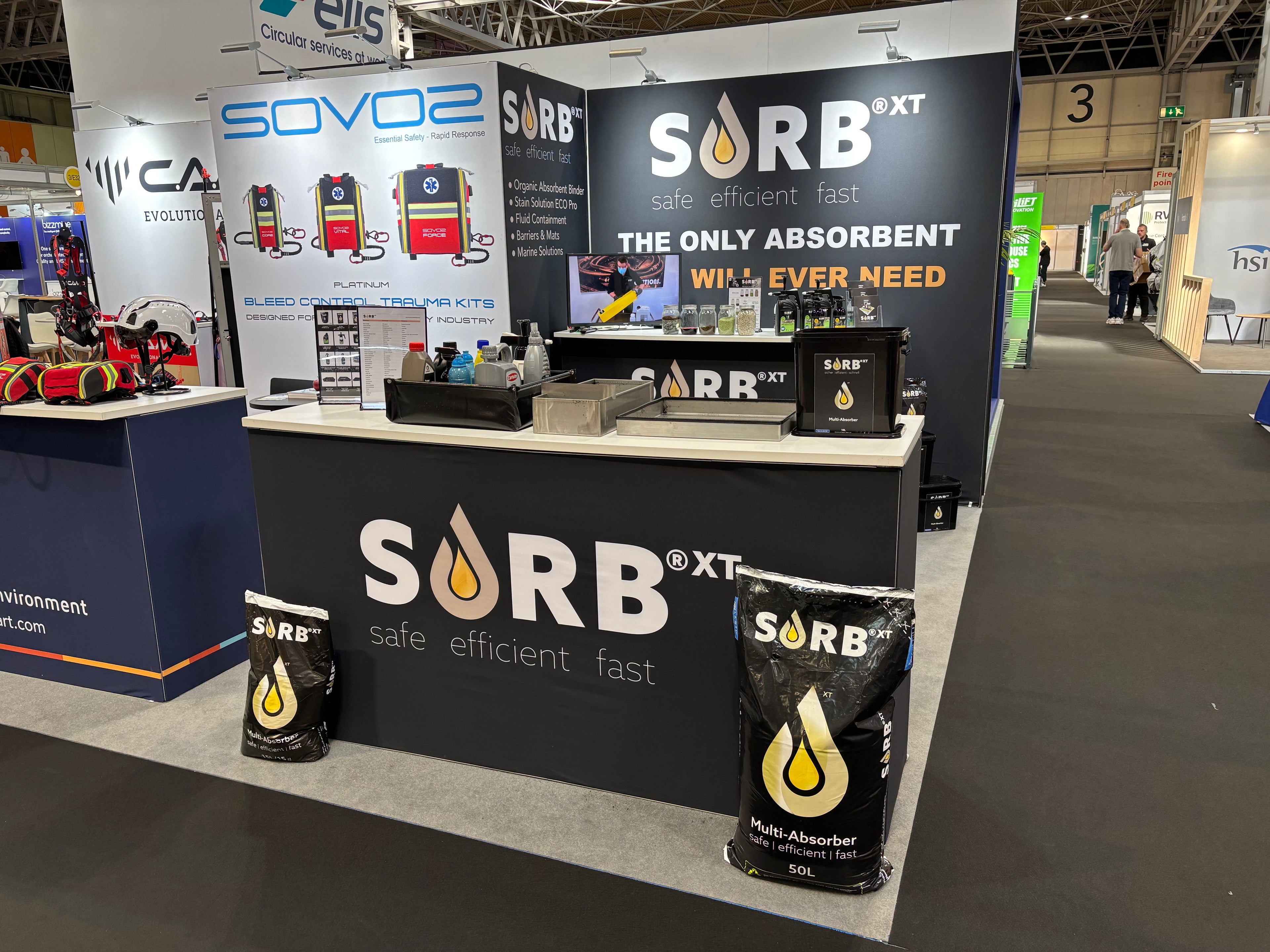 SORB XT booth at a trade show with promotional materials and branding.