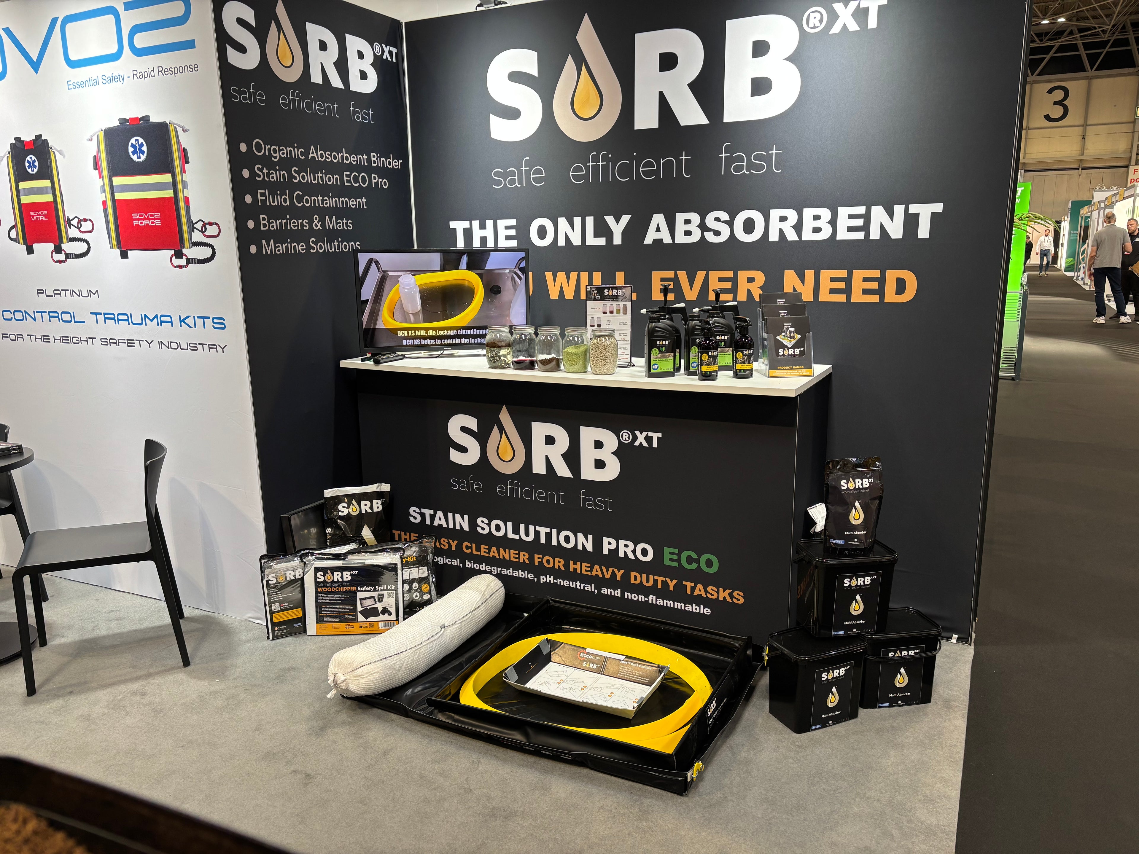 SORB XT booth display at an exhibition with various products and branding.