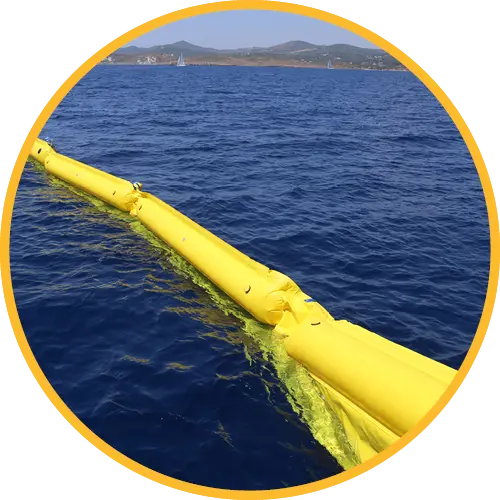 Yellow inflatable barrier on a body of water with mountains in the background